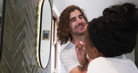 Playful Grooming Session with Joyful Couple at Home