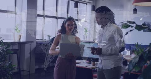 Team Analyzing Data in Modern Office with Digital Map Overlay