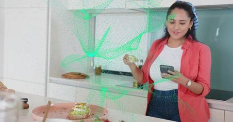 Indian Woman Prepares Healthy Avocado Toast Using Smartphone for Recipe