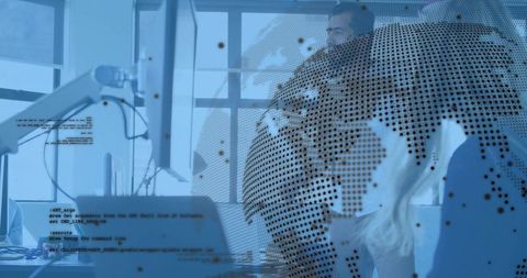 Team collaborating around monitors with dotted globe overlay and digital data visualization