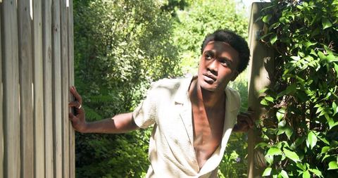 Man enjoys tranquil moment in lush green backyard garden