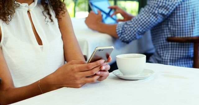 People in cafe using smartphone and tablet - Download Free Stock Images Pikwizard.com