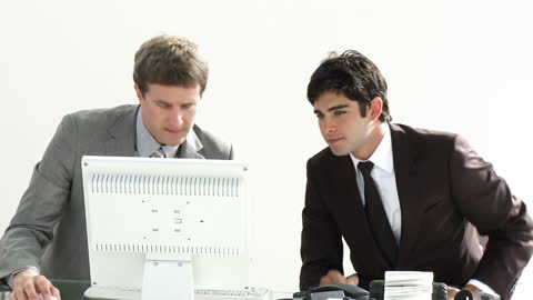 Business Colleagues Collaborating at Workstation