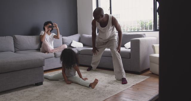 Family Bonding Time with Mixed Race Father and Daughter Exercising at Home - Download Free Stock Images Pikwizard.com