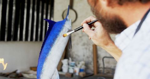 Artisan craftsmanship: painting and decorating fish specimen