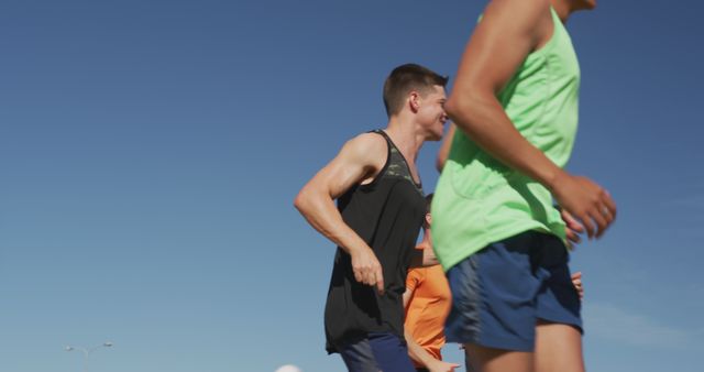 Group of Friends Jogging Outdoors Under Clear Blue Sky - Download Free Stock Images Pikwizard.com