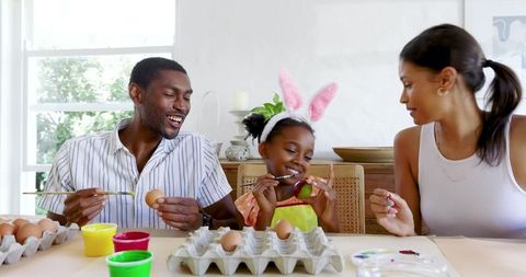 Family Bonding with Easter Egg Painting Activity at Kitchen Table
