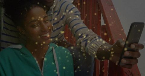 Young friends capturing moments on outdoor stairs