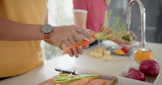 Cooking preparation, people washing carrots in modern kitchen - Download Free Stock Images Pikwizard.com