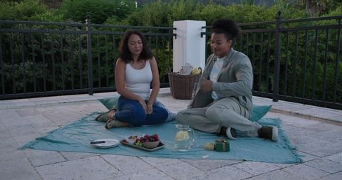 Couple Having Romantic Picnic on Terrace with Scenic Mountain View