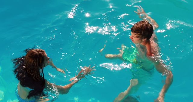 Two Teens Having Fun Swimming in Pool on Sunny Day - Download Free Stock Images Pikwizard.com