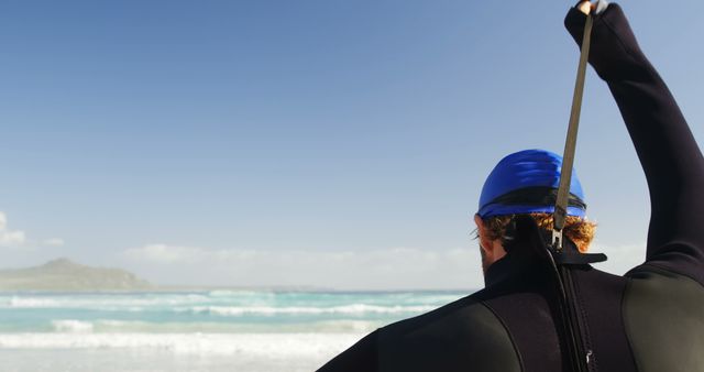 Surfer Preparing Wetsuit for Beach Adventure on Sunny Day - Download Free Stock Images Pikwizard.com