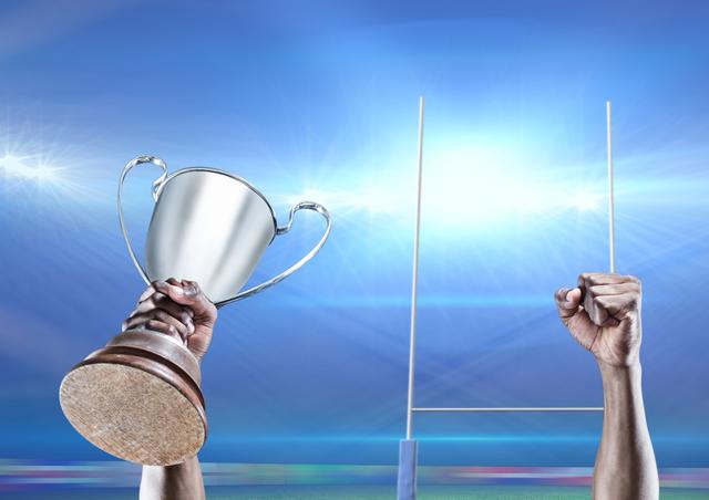 Digital composition of player lifting trophy against goal post in background