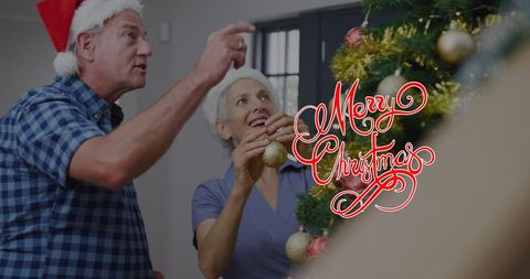 Senior Couple Decorating Christmas Tree with Joy