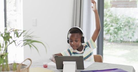 African American Boy Engaged in Interactive Online Learning at Home
