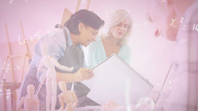 Two senior women are deeply focused in an art studio, engaging in painting. Collaboration and creativity fill the workspace, suggesting an environment rich in artistic expression and lifelong learning. Suitable for promoting art classes for seniors, celebrating the joy of creativity, or illustrating collaboration among diverse age groups.