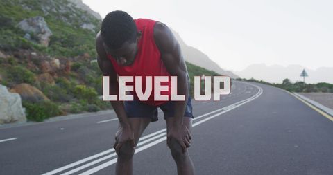 Determined Athlete Taking a Rest on Open Mountain Road