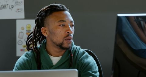 Focused Executive Working at Computer in Office Workspace
