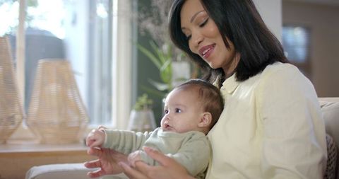 Mother Bonding with Baby in Sunlit Living Room Interior