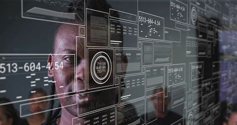 Tech professional analyzing transparent data dashboards on glass ui in collaborative hub
