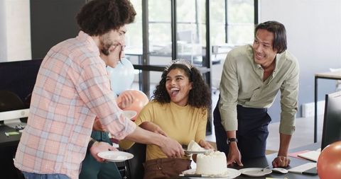 Team Celebrating Colleague's Birthday with Cake in Modern Office