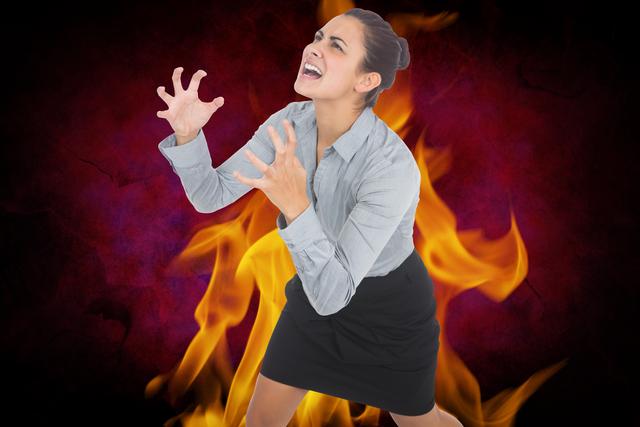 Digital composite of Digital composite image of aggressive businesswoman with fire