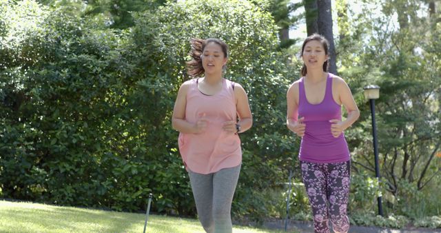 Two Women Jogging in Park on a Sunny Day - Download Free Stock Images Pikwizard.com