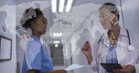 Collaborating clinicians sharing charts and tablet with global health map overlay