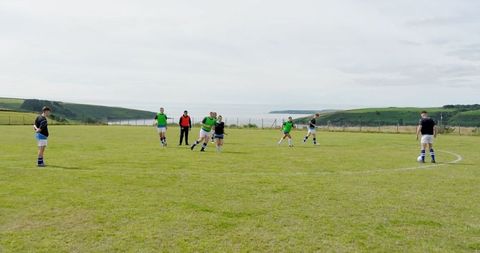 Team Soccer Practice on Coastal Field with Vibrant Backdrop