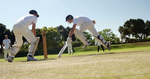 Cricket Players Engaged in Intense Game on Sunny Day - Download Free Stock Images Pikwizard.com