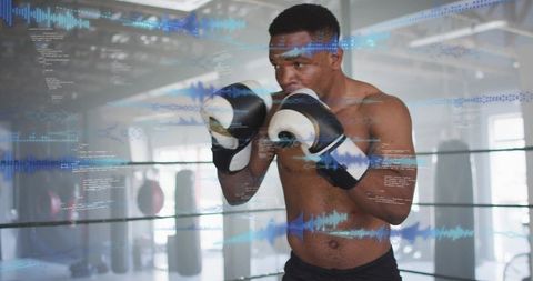 Determined boxer training in ring with digital data overlays and waveform analytics