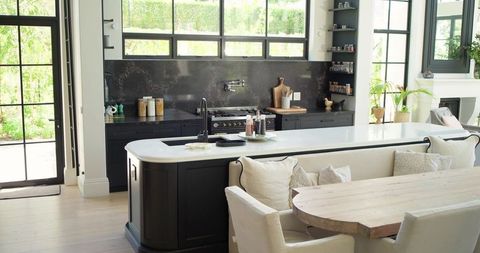Sunlit contemporary kitchen island anchoring open-plan living with white quartz countertop