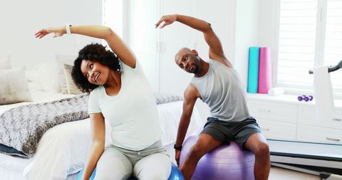 Couple Enjoying Home Fitness Routine with Exercise Balls - Download Free Stock Images Pikwizard.com