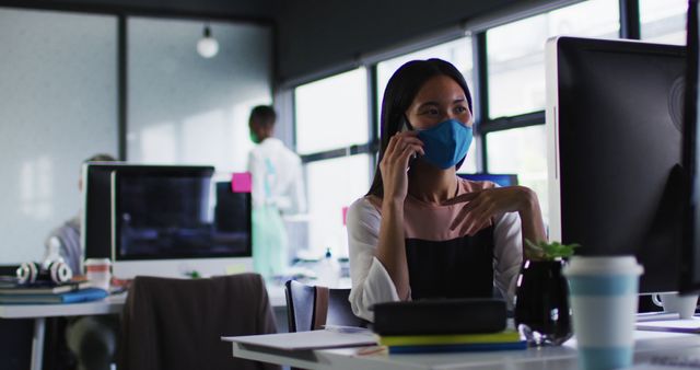 Office Workers Wearing Masks and Engaging in Work Amidst COVID-19 Pandemic - Download Free Stock Images Pikwizard.com