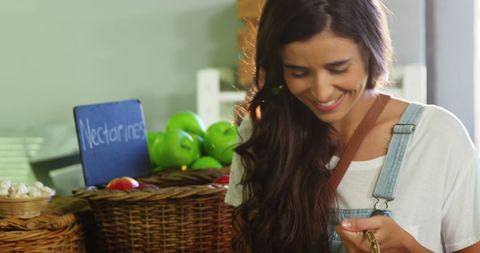 Smiling woman shopping in local fruit market