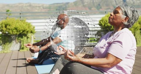 Senior meditation on rooftop with holographic globe of connection