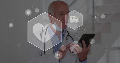 Senior physician checking tablet with hexagonal telemedicine interface in clinic corridor