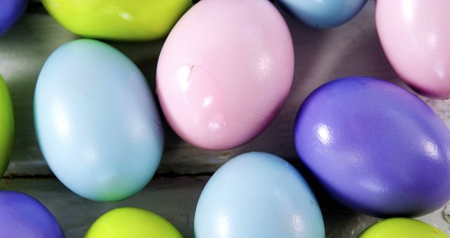 Colorful Easter eggs are arranged neatly, showcasing a variety of pastel hues, with copy space. These eggs symbolize the festive spirit of Easter and are often used in hunts and decorations during the holiday.