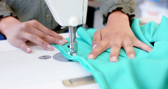 Close-up of hands sewing fabric on a sewing machine - Download Free Stock Images Pikwizard.com