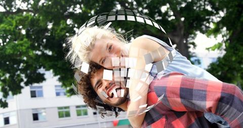 Playful couple sharing piggyback ride in urban park enjoying green canopy with mosaic overlay