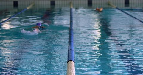 Swimmers in Lane Race Showcasing Athletic Rivalry