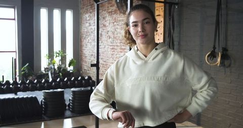Confident Young Woman Resting After Training in Gym