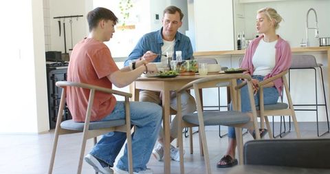 Family enjoying healthy meal at modern kitchen dining table