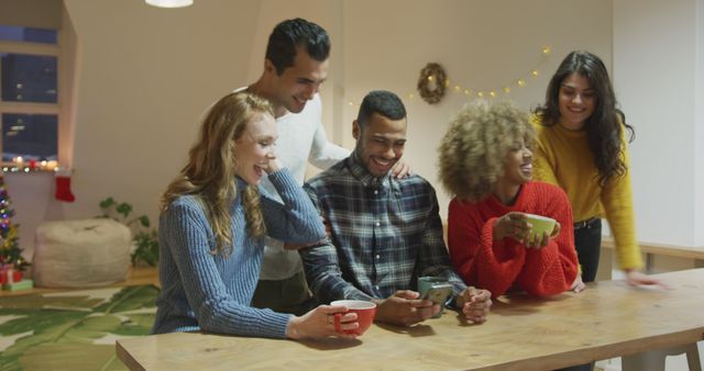 Friends Enjoying Hot Beverages and Laughing Together Indoors - Download Free Stock Images Pikwizard.com