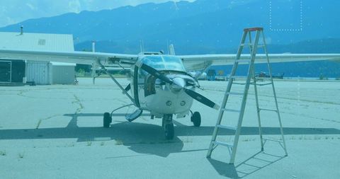 Small single-engine propeller aircraft parked in airport