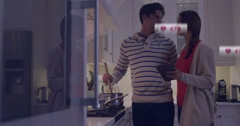 Couple Cooking Together with Tech Icons in Modern Kitchen