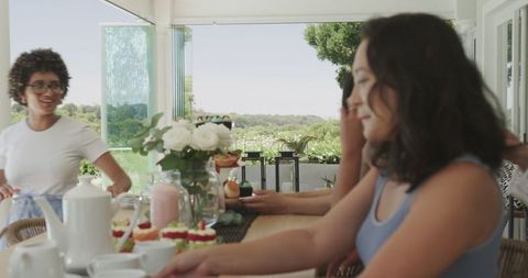 Friends Conversing at Outdoor Celebration Table