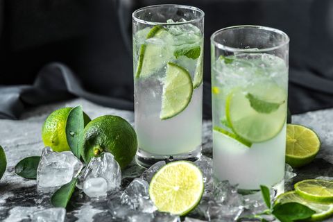 Refreshing lime-infused cocktails with ice and mint garnish