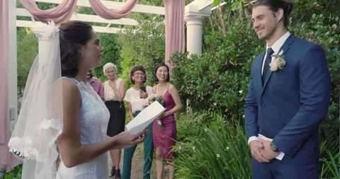 Bride Reading Vows to Groom at Outdoor Wedding Ceremony