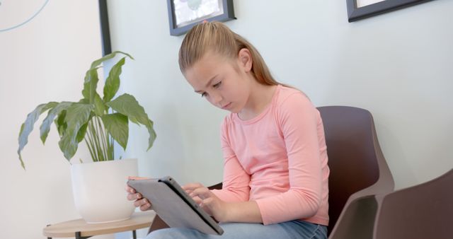 Young girl using digital tablet in modern living room - Download Free Stock Images Pikwizard.com
